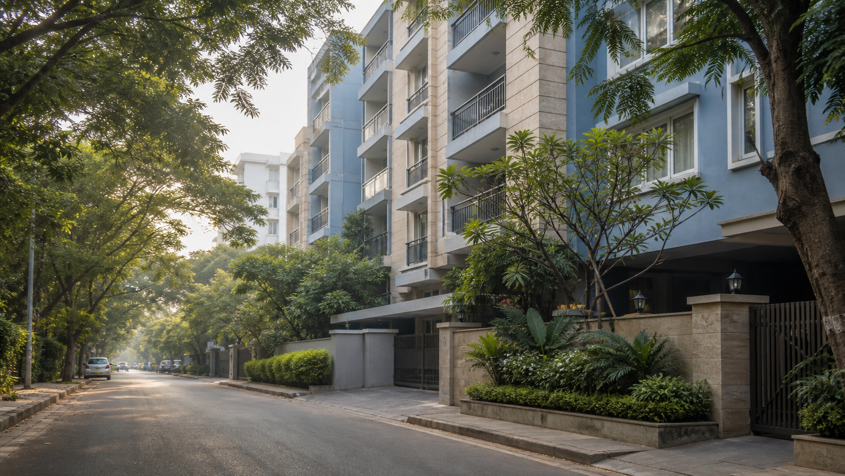 Leafy residential street beside apartment buildings in Bengaluru